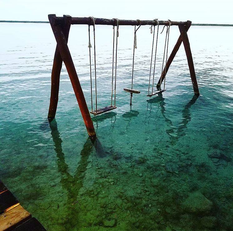 Swing over crystal clear waters of Lake Bacalar